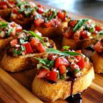 Delicious bruschetta appetizers topped with fresh tomatoes, basil, and balsamic glaze on toasted bread.
