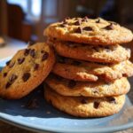 A stack of freshly baked Air Fryer Cookies with chocolate chips on a blue plate, ready to eat.