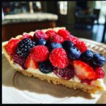 Slice of berry tart with raspberries, blueberries, strawberries, and blackberries. Healthy Game Day Desserts.