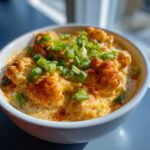 Bowl of creamy Buffalo Cauliflower Dip topped with green onions, ready to be served.