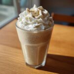 A delicious vanilla bean frappuccino topped with whipped cream and a sprinkle of spice.