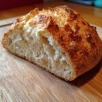 Close-up of vegan bread, a perfect addition to game day recipes, showcasing its crust and soft interior.