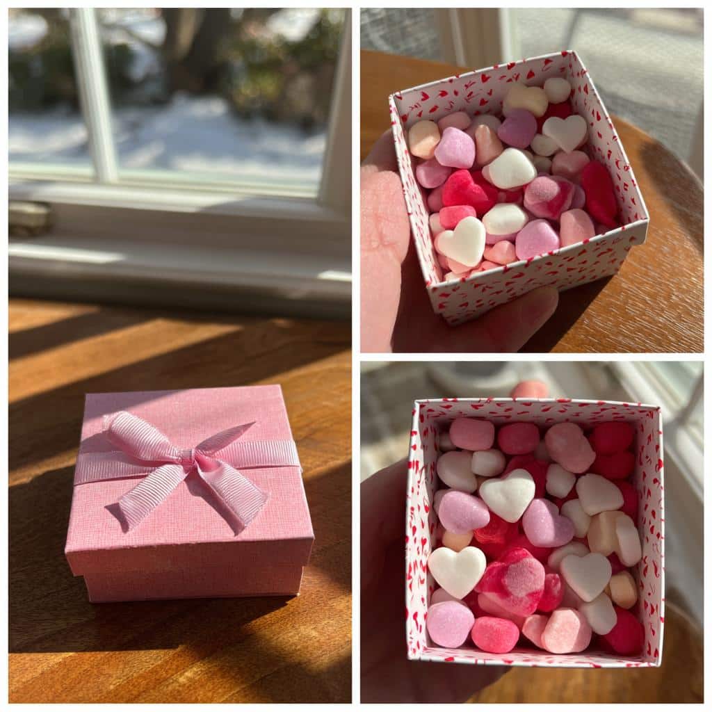 A pink Galentine’s candy gift box filled with heart-shaped candies in pink, red, and white.