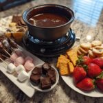 Valentine’s chocolate fondue set with strawberries, cookies, marshmallows, and chocolate-covered dippers.
